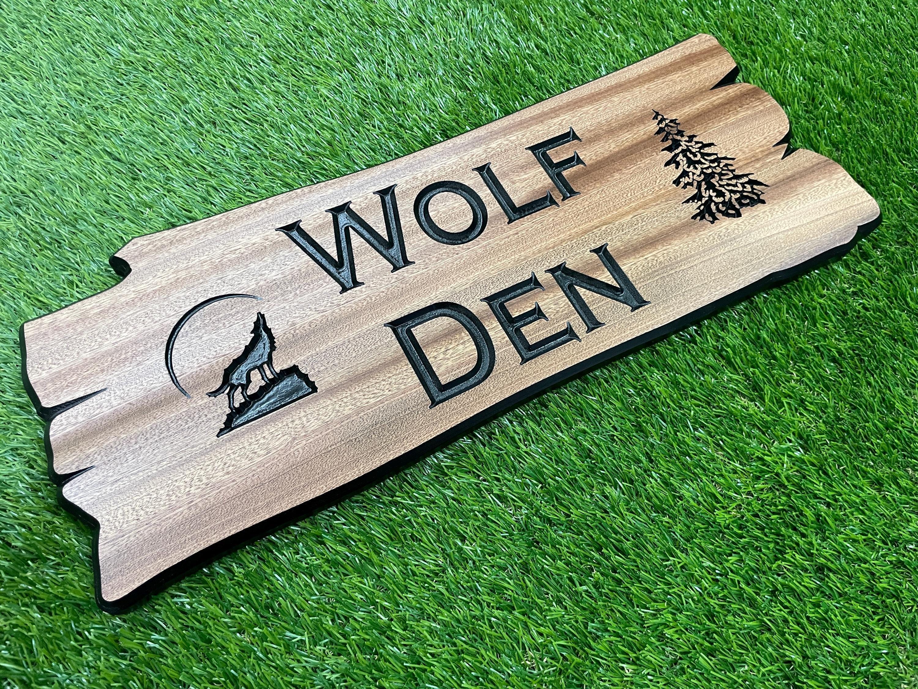 a wooden sign that says wolf den on it