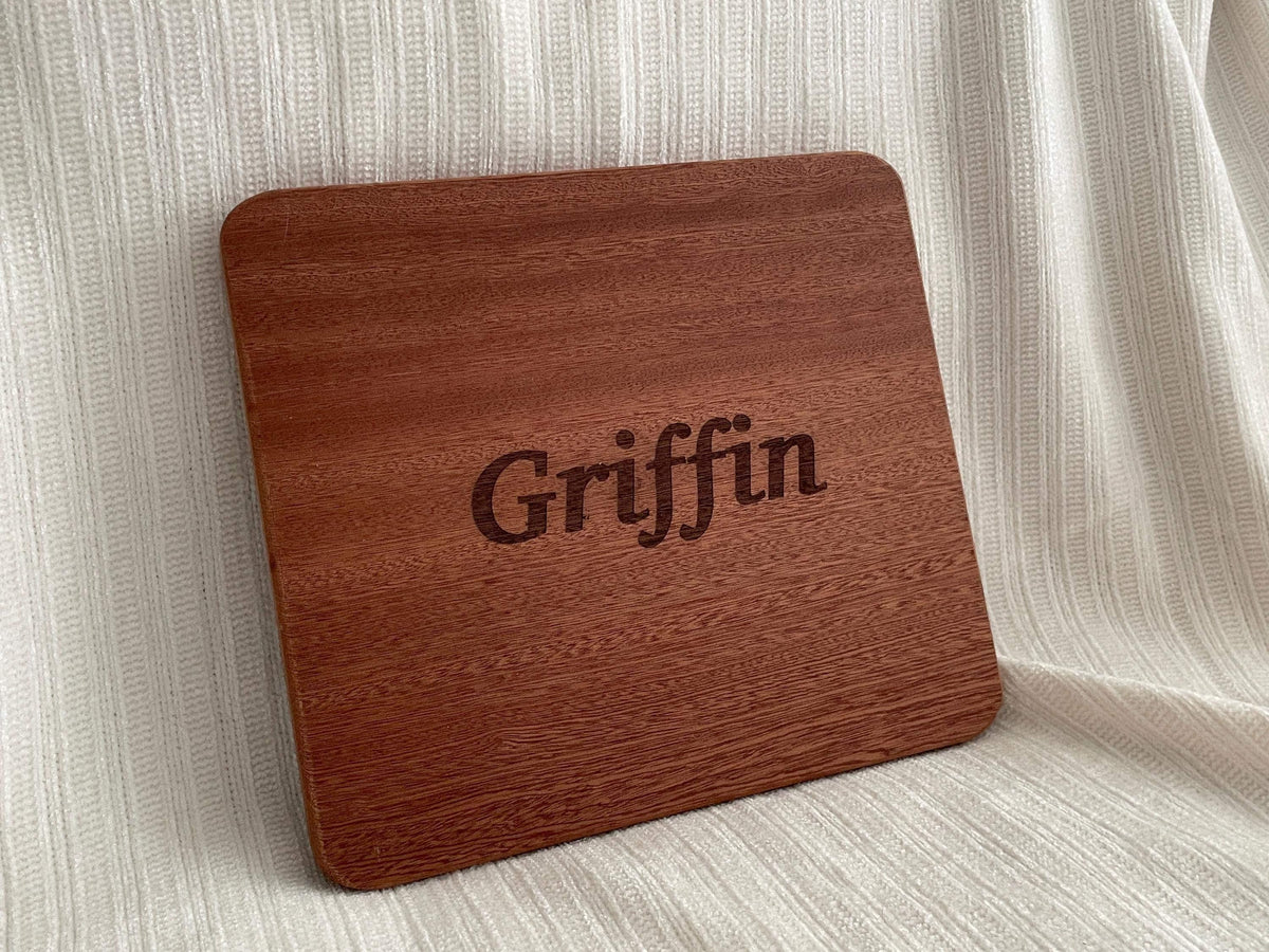 A wooden cutting board with the name "Griffin" engraved on it.