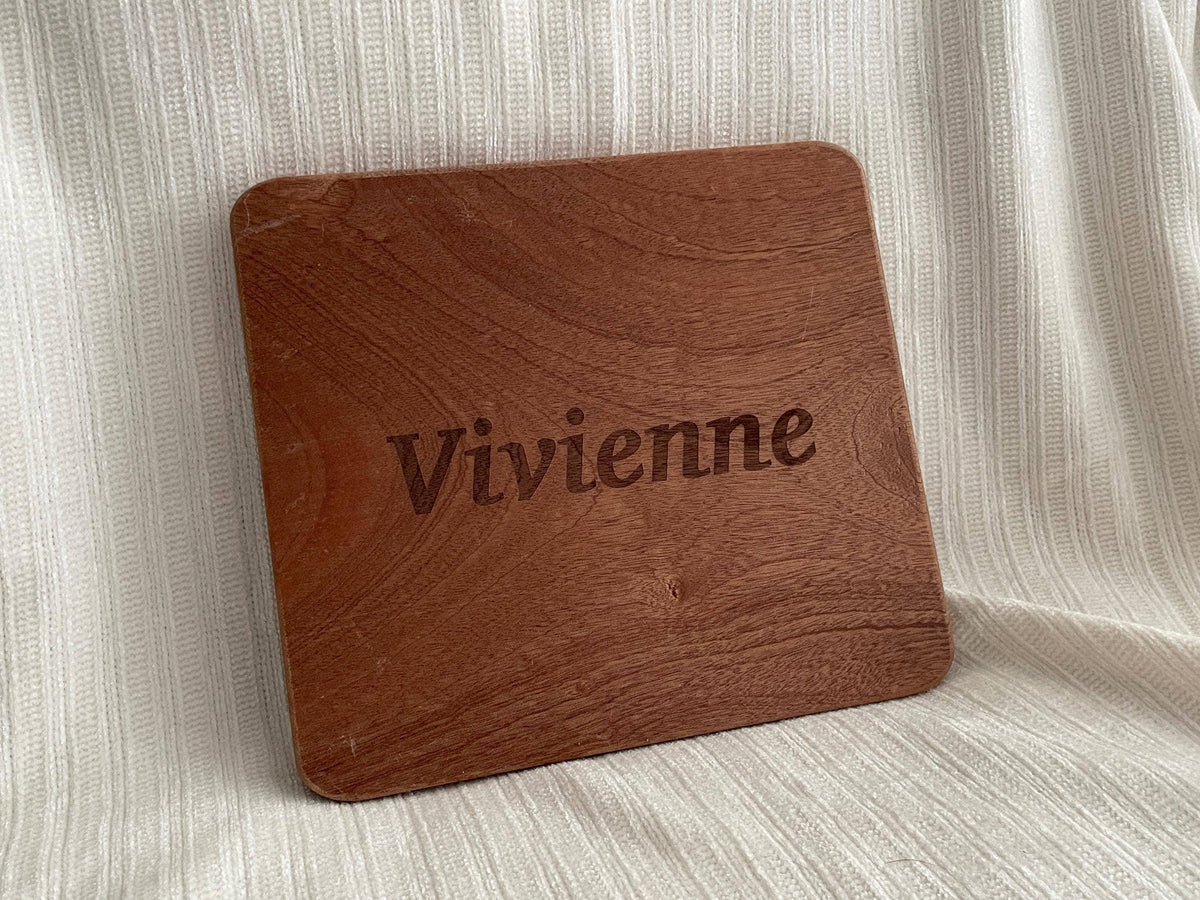 A wooden cutting board with the name 'Vivienne' engraved on it.