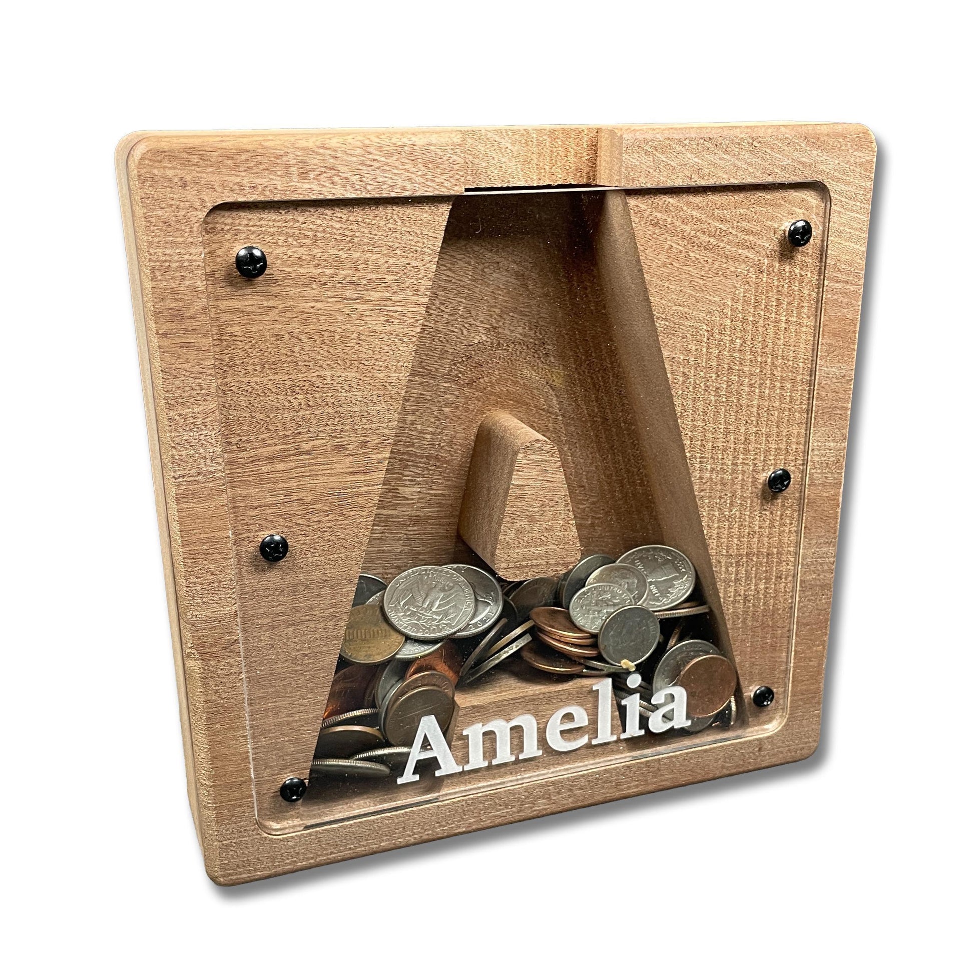 A wooden coin bank with a nameplate inside, containing various coins.