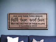 a wooden sign that says and now these three remain faith hope and love but the