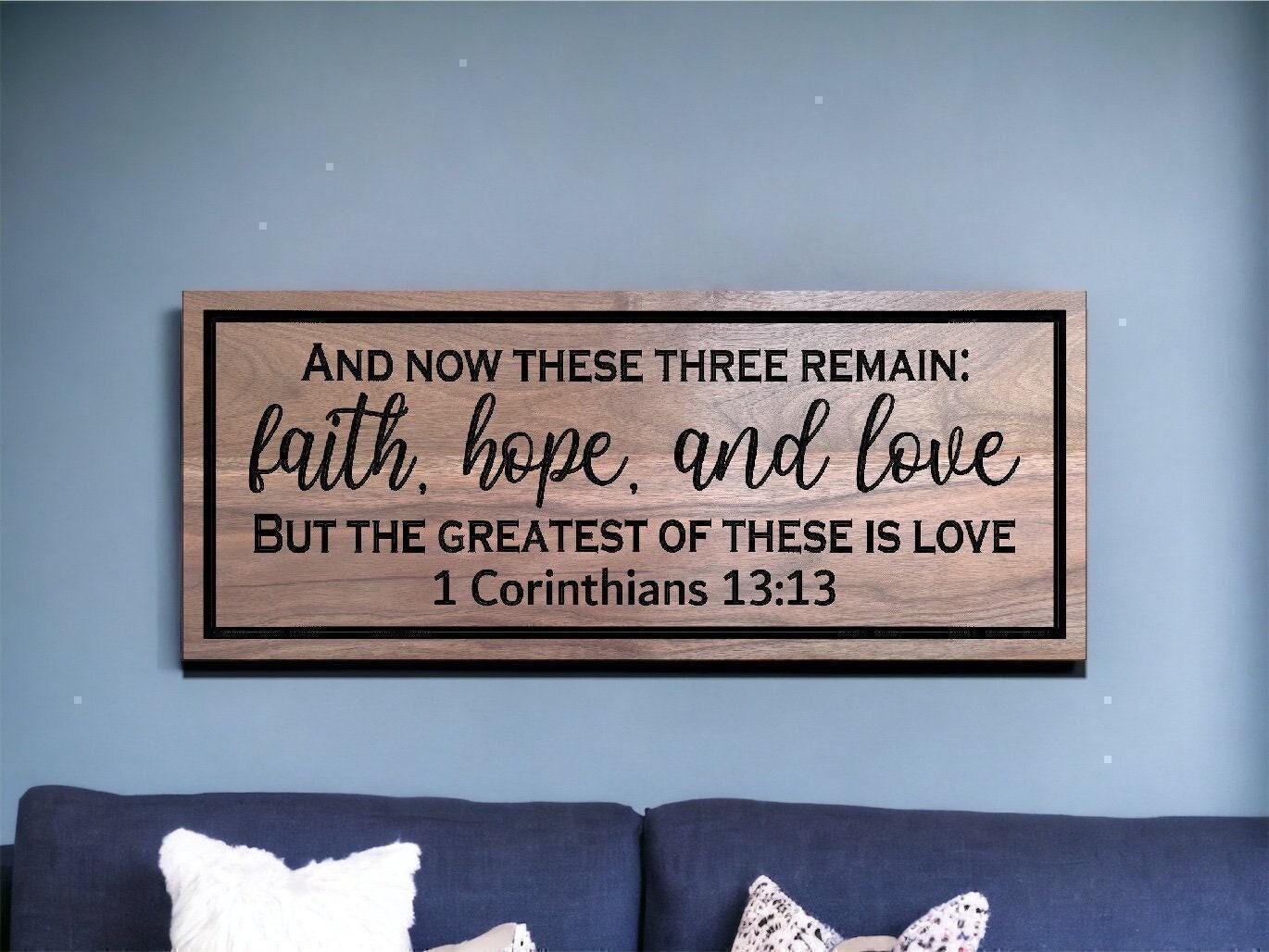 a wooden sign that says and now these three remain faith hope and love but the