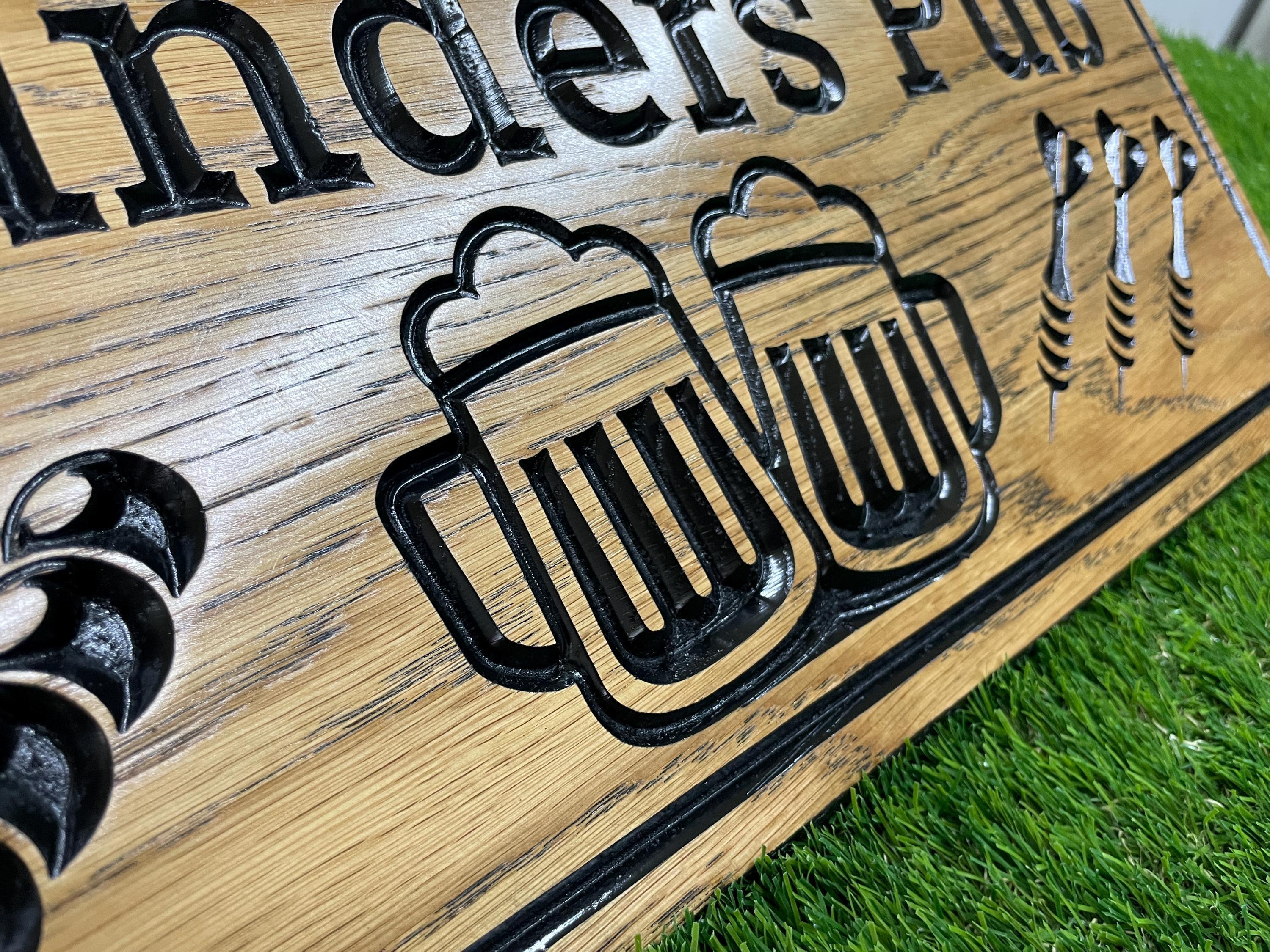a close up of a wooden sign on the grass