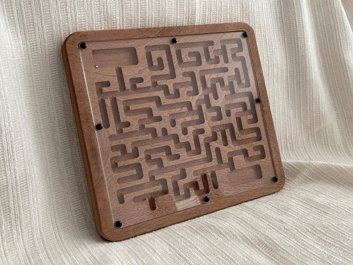 A wooden maze puzzle with a clear plastic cover, designed to be a brain-teaser or puzzle game.