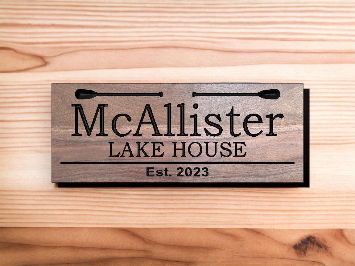 a wooden sign that says mcallister lake house