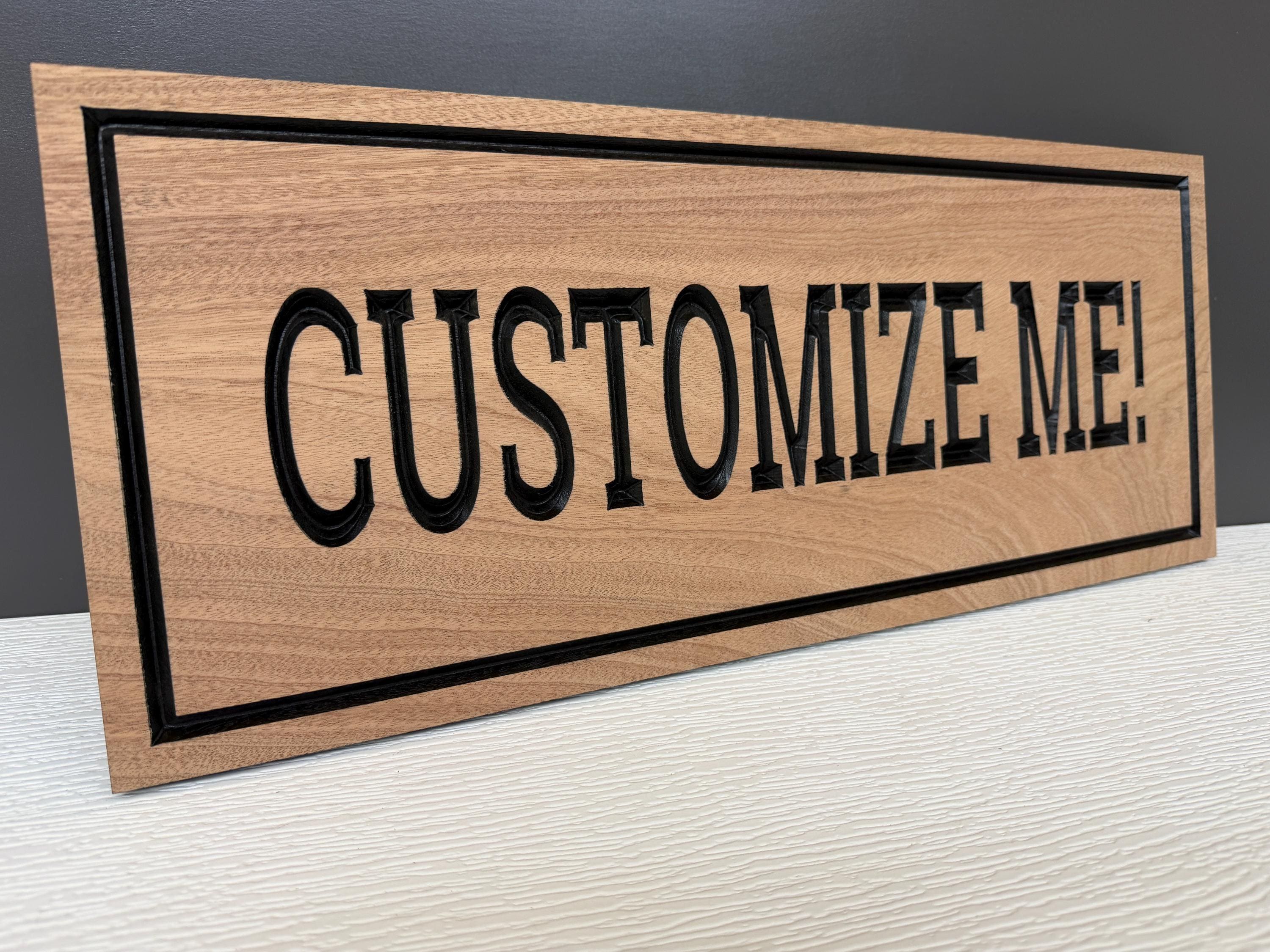 A wooden sign with the text "CUSTOMIZE ME!" carved into it.