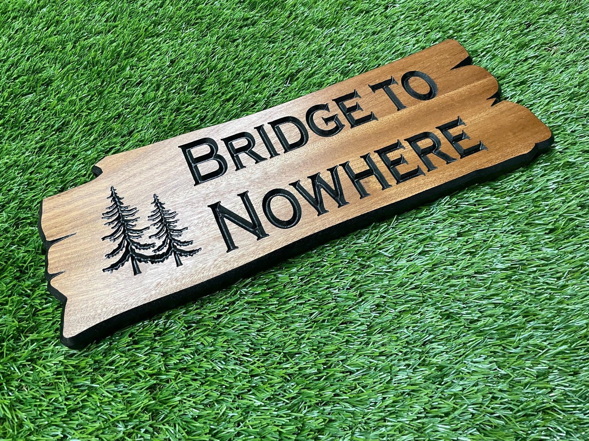 a wooden sign that says bridge to nowhere