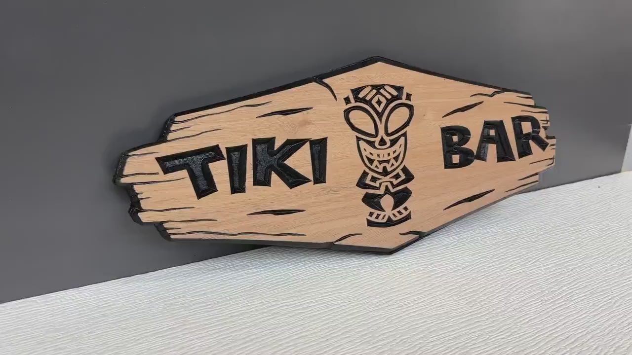 Load video: Personalized Tiki Bar Sign Custom Wood, Tiki Bar Name Sign, Tropical Bar Decor Carved, Backyard Tiki Hut Name Sign Hawaiian Gift